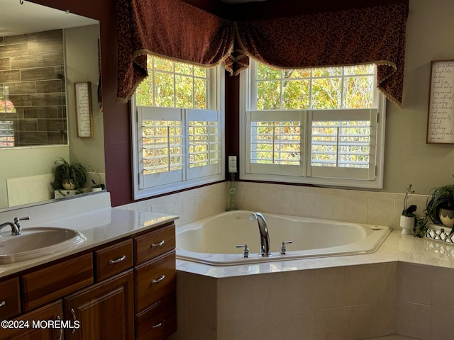 bathroom featuring vanity and tiled bath