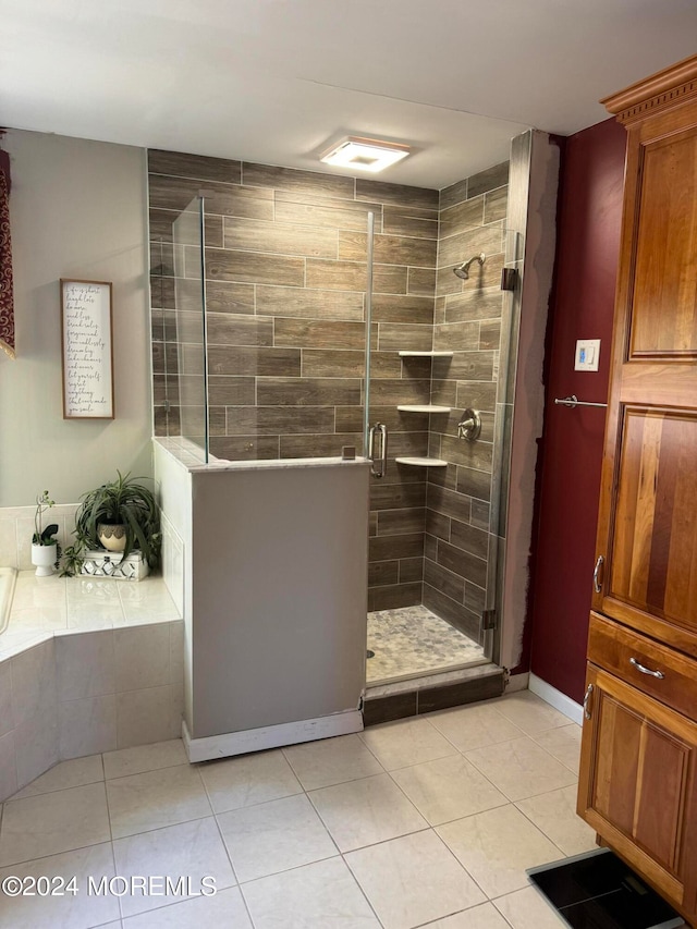 bathroom featuring tile patterned floors and independent shower and bath