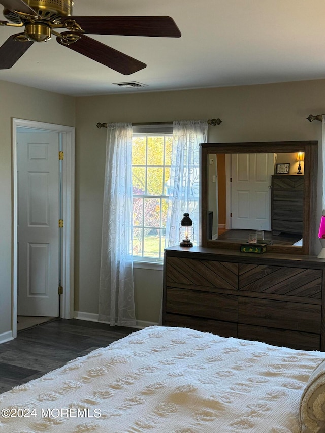 unfurnished bedroom featuring dark hardwood / wood-style floors and ceiling fan