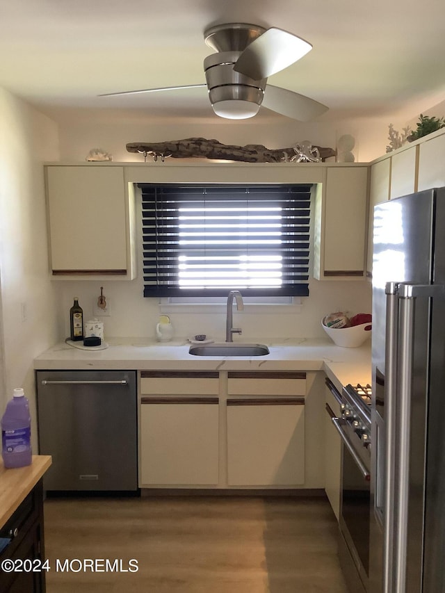 kitchen with cream cabinets, ceiling fan, dark hardwood / wood-style floors, sink, and stainless steel appliances