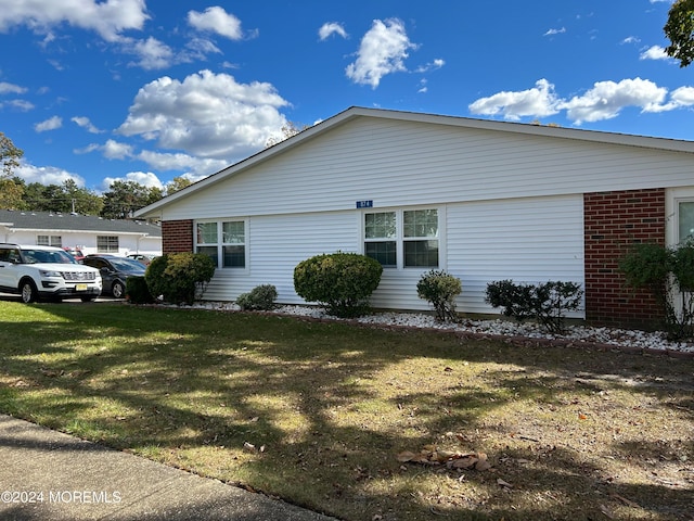 view of side of home featuring a lawn