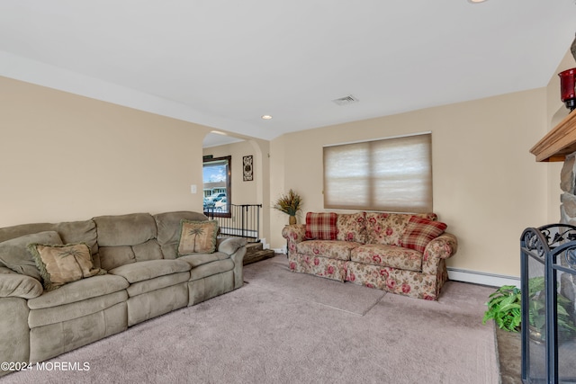 living room featuring light colored carpet and baseboard heating