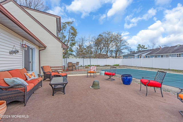 view of patio / terrace with an outdoor hangout area and a covered pool