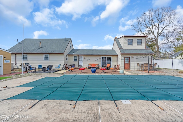 view of swimming pool with grilling area, outdoor lounge area, and a patio