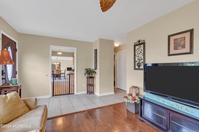 living room featuring a notable chandelier and light wood-type flooring