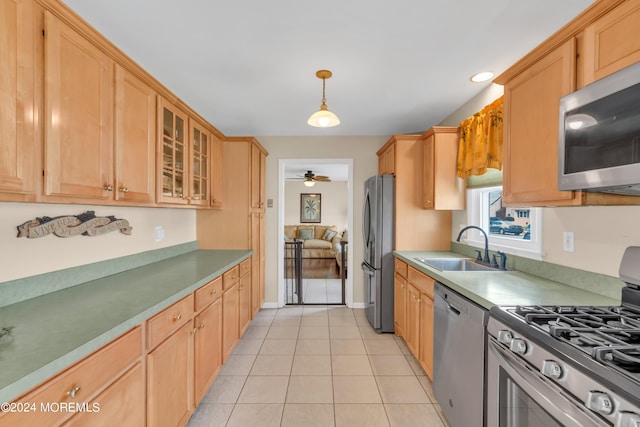 kitchen featuring sink, ceiling fan, decorative light fixtures, light tile patterned flooring, and stainless steel appliances