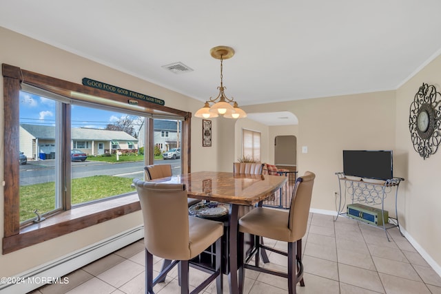 dining room featuring a notable chandelier, baseboard heating, crown molding, and light tile patterned flooring