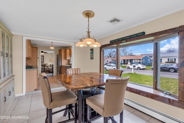 dining space with an inviting chandelier, light tile patterned flooring, and a baseboard heating unit