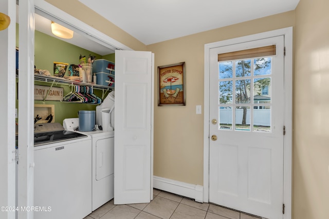 laundry room with light tile patterned floors, washing machine and dryer, and a baseboard radiator