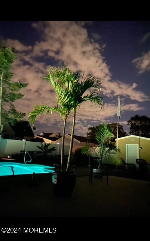 view of pool at dusk