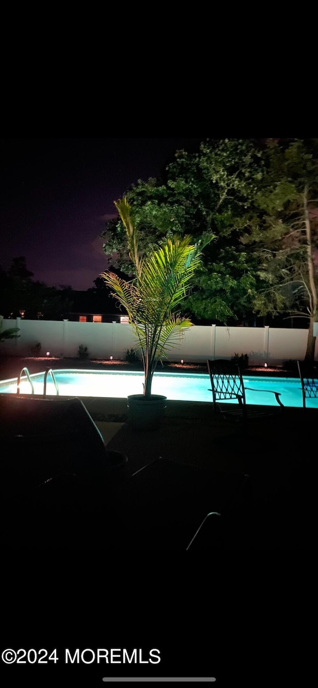 view of pool at night