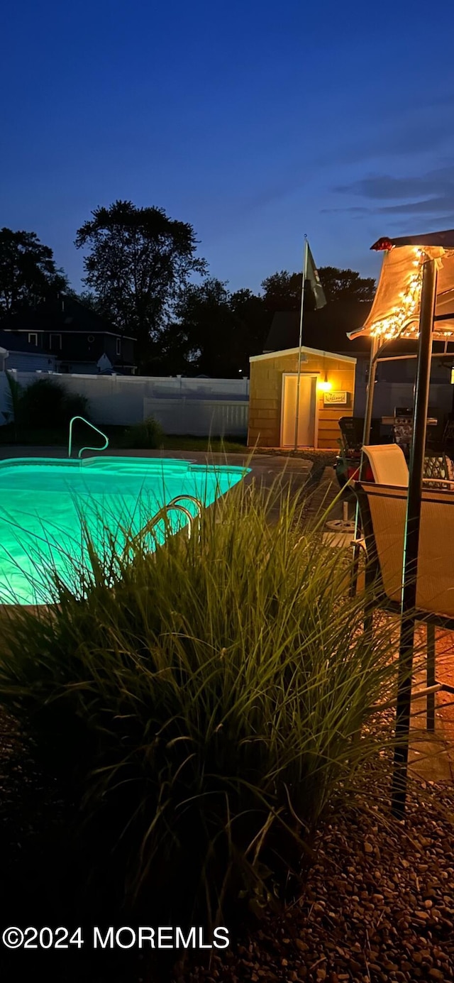 view of pool at dusk