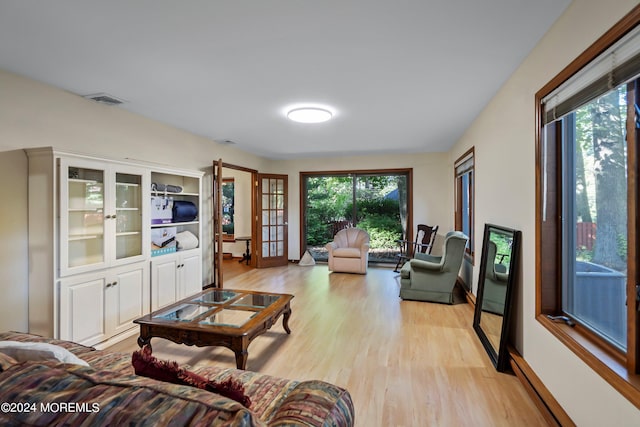 living room with french doors and light hardwood / wood-style flooring