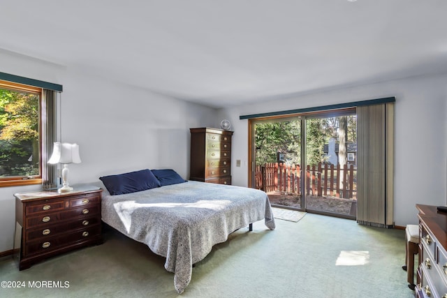 bedroom featuring access to outside and light colored carpet