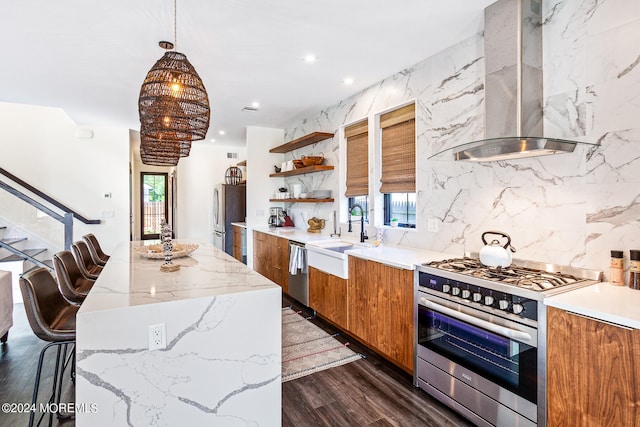 kitchen featuring sink, wall chimney exhaust hood, stainless steel appliances, dark hardwood / wood-style floors, and a center island