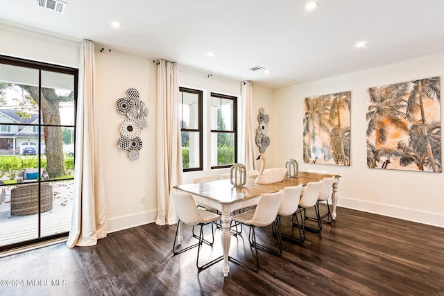 dining area with a healthy amount of sunlight and dark hardwood / wood-style flooring