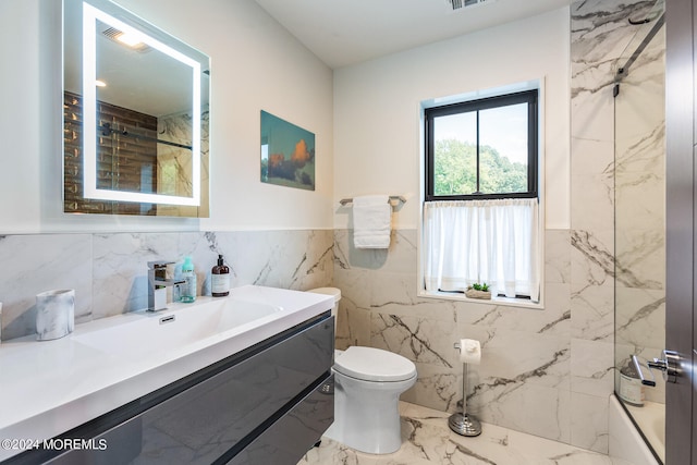 bathroom with walk in shower, vanity, tile walls, and toilet