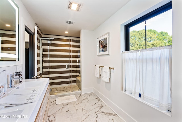 bathroom featuring vanity and a shower with shower door