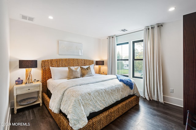 bedroom with dark hardwood / wood-style floors