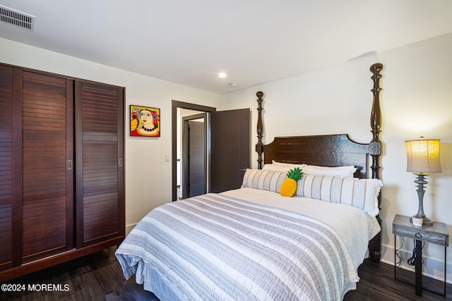 bedroom with dark hardwood / wood-style floors