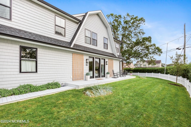 back of house featuring a yard and a patio area