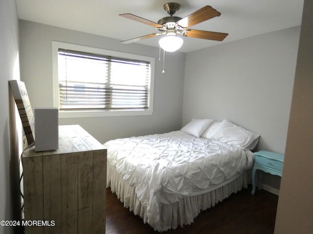 bedroom with ceiling fan and dark hardwood / wood-style floors