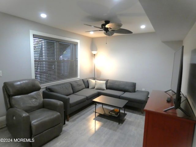 living room featuring ceiling fan and light wood-type flooring