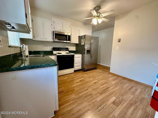 kitchen with sink, ceiling fan, stainless steel appliances, white cabinets, and light hardwood / wood-style flooring