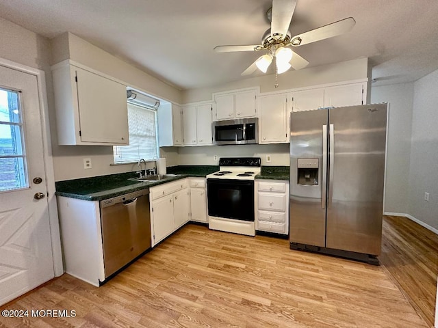 kitchen featuring sink, white cabinetry, stainless steel appliances, and a healthy amount of sunlight