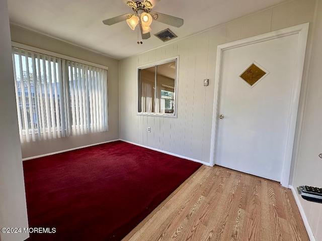 unfurnished room with ceiling fan, plenty of natural light, and light wood-type flooring