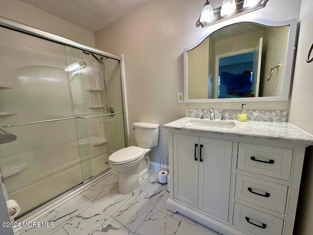 bathroom with vanity, a shower with shower door, and toilet