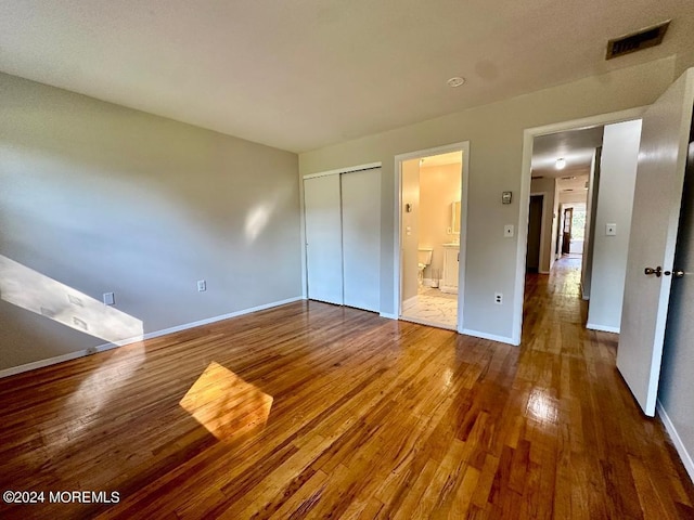 259 Laurel Pl Unit A, Manchester, NJ 08759 - unfurnished bedroom featuring hardwood / wood-style floors, baseboards, a closet, and connected bathroom