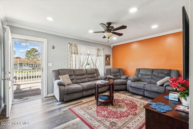 living room with ornamental molding, a healthy amount of sunlight, ceiling fan, and wood-type flooring