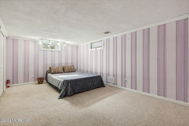 carpeted bedroom with a textured ceiling