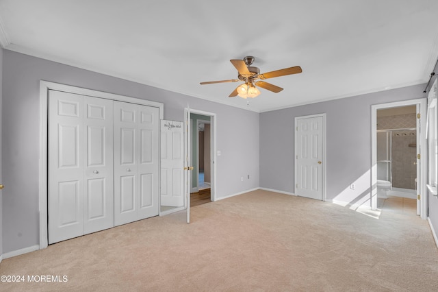 unfurnished bedroom with ceiling fan, light colored carpet, ensuite bathroom, and ornamental molding