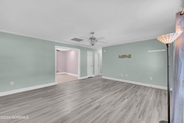 spare room featuring crown molding, ceiling fan, and light hardwood / wood-style flooring