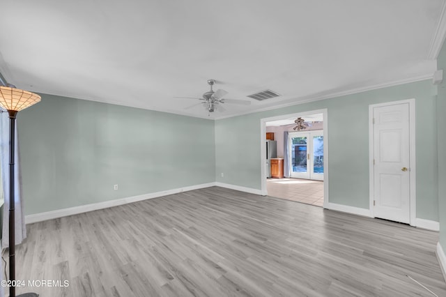 spare room with light hardwood / wood-style floors, ornamental molding, french doors, and ceiling fan