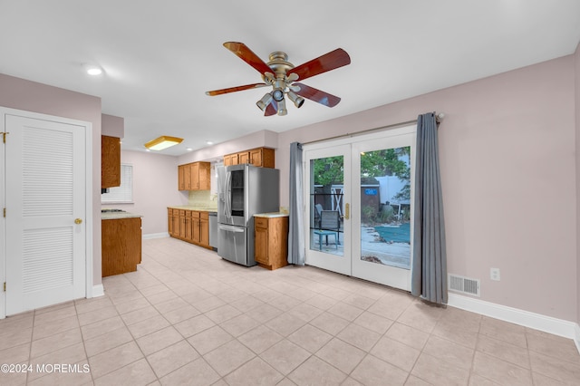 kitchen with light tile patterned floors, french doors, ceiling fan, and appliances with stainless steel finishes