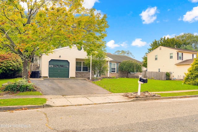 view of front of property with a garage and a front lawn