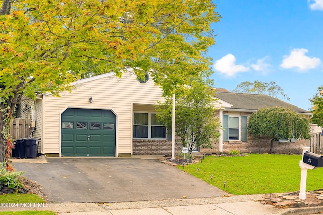 ranch-style house featuring a garage and a front yard