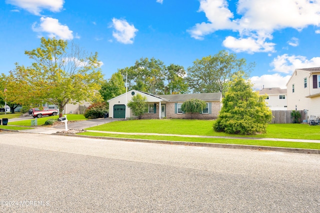 view of front of property featuring a garage and a front lawn