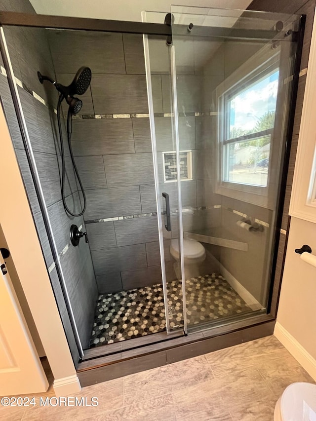 bathroom with toilet and a shower stall