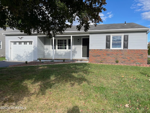 ranch-style home with an attached garage, brick siding, driveway, and a front yard