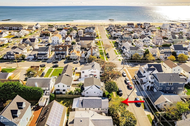 drone / aerial view with a water view and a view of the beach