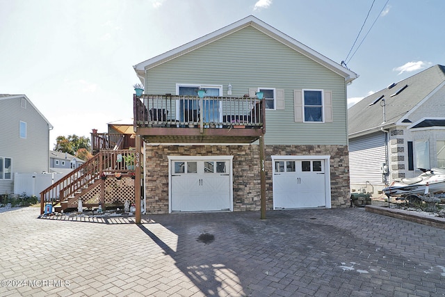 rear view of house featuring a garage