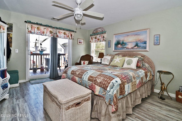 bedroom with wood-type flooring, access to outside, and ceiling fan