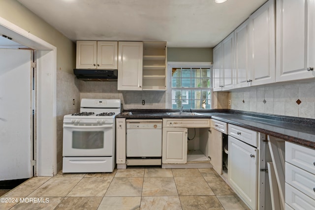 kitchen with decorative backsplash, white cabinets, sink, and white appliances