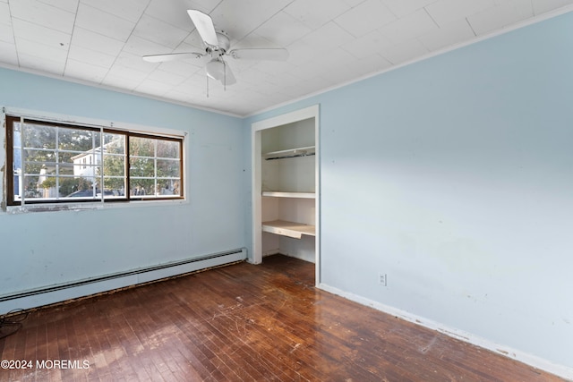 unfurnished bedroom featuring a closet, ceiling fan, baseboard heating, crown molding, and dark hardwood / wood-style floors