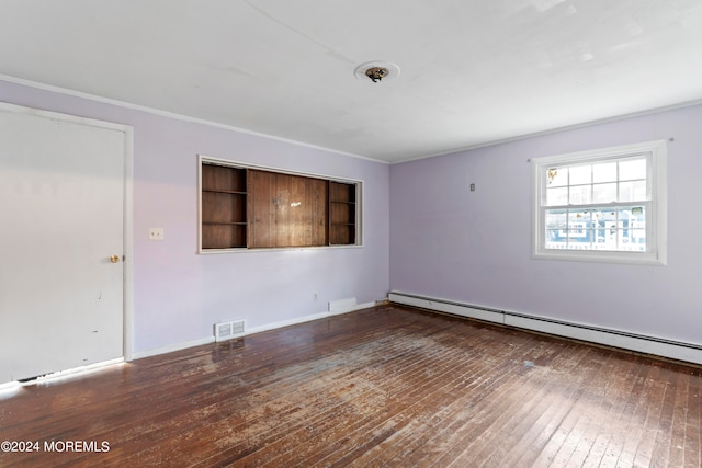 unfurnished room with dark wood-type flooring, ornamental molding, and a baseboard heating unit