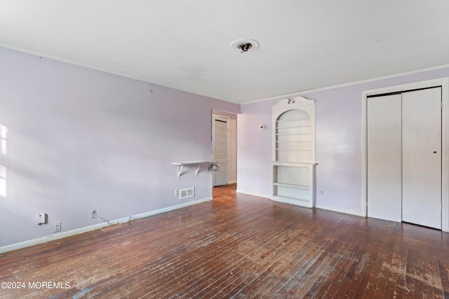 unfurnished bedroom with dark hardwood / wood-style flooring